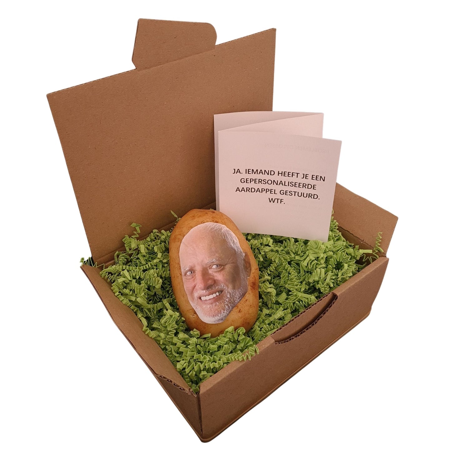 Een pakket met daarin een aardappel met daarop het uitgeknipte hoofd van Hide the Pain Harold. Een wit zigzak boekje met de tekst “Ja, iemand heeft je een gepersonaliseerde aardappel gestuurd. WTF.” Verpakt in een hysterisch groen verpakkingsmateriaal.